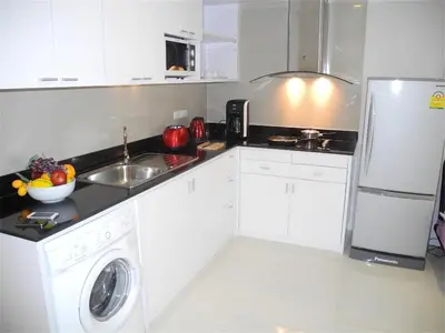 a white kitchen with a sink and a dishwasher at Ideally Apartment close to Kata Beach in Kata Beach