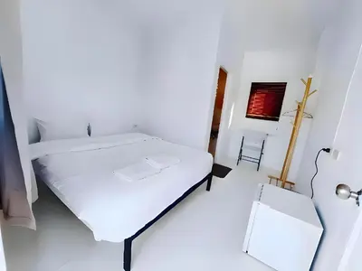 a white bedroom with a bed and a mirror at XX BAO Patong Beach Phuket - เบา ป่าตอง in Patong Beach