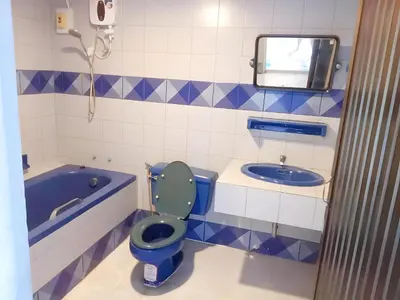 a bathroom with a blue toilet and a tub at xx Mitr INN Phuket Oldtown - มิตร ภูเก็ต in Phuket Town