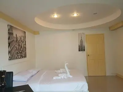 a bedroom with a bed with a swan on it at Sea Breeze Patong Holiday Condo in Patong Beach