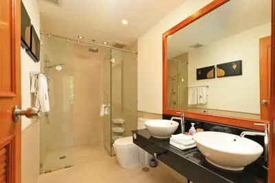 a bathroom with two sinks and a shower at Tropical Holiday Home at Laguna Phuket in Layan Beach