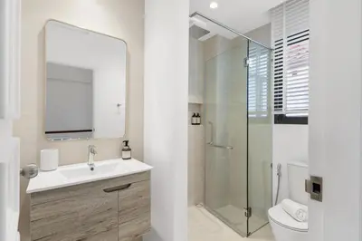 a bathroom with a sink and a glass shower at Coastal Villa on Fairway in Phuket