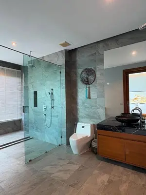 a bathroom with a shower and a toilet and a sink at Villa Sa in Ban Saiyuan (1)
