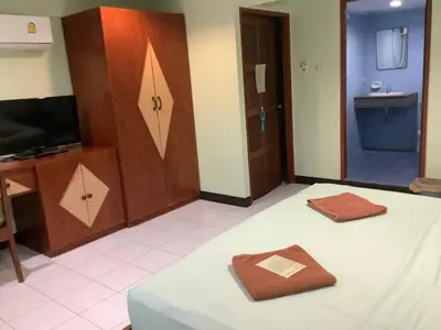 a room with a bed with a tv and a door at Freedom house in Karon Beach