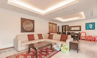 a living room with a couch and a table at 4 BR Jacuzzi Pool Villa with Playground, near Layan, Laguna, Bang Tao beach in Ban Pak Lak