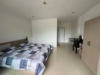 a bedroom with a large bed and a desk at Come see comsa in Koh Lone