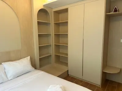 a bedroom with a bed and a closet at Kamala Apartments in Kamala Beach