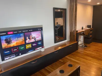 a large flat screen tv sitting on a wall at Rawai Title 3 in Rawai Beach