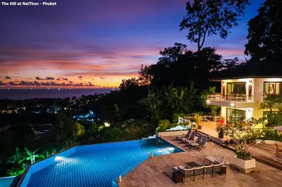 a villa with a swimming pool at night at Great view pool villas in Phuket