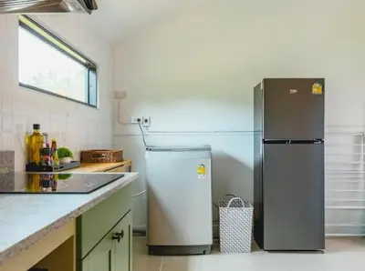 a kitchen with a refrigerator and a sink at Wink Garden 3 Bedrooms Bangtao Beach Phuket in Ban Thalat Choeng Thale