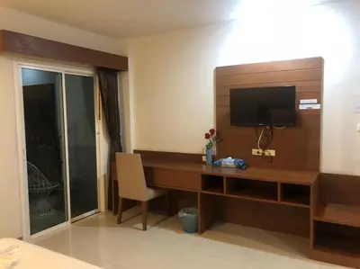 a hotel room with a desk with a television on it at Chollada inn kamala in Kamala Beach