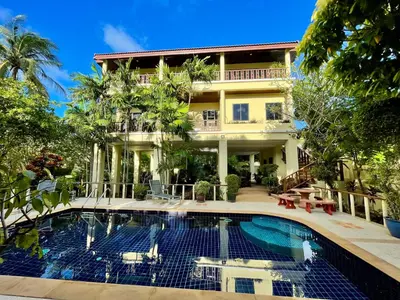 a hotel with a swimming pool in front of a building at Kata Sunset Bay Villa - 3BR Private Pool - Seaview in Kata Beach