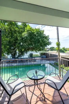 a patio with a table and chairs and a swimming pool at Antiya Hotel Phuket in Phuket Town
