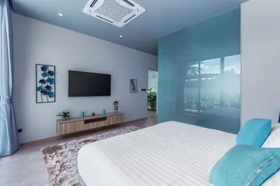 a bedroom with a large bed and a flat screen tv at Stylish 2BR Naiton Aileen Villa w Private Pool in Nai Thon Beach