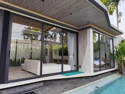 a house with glass doors and a pool at Stylish 2BR Naiton Aileen Villa w Private Pool in Nai Thon Beach