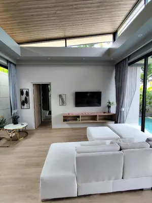 a living room with a white couch and a tv at Stylish 2BR Naiton Aileen Villa w Private Pool in Nai Thon Beach