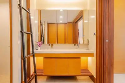 a bathroom with a sink and a large mirror at Elegant Beachfront 3BR Condo at Pearl of Naithon in Nai Thon Beach