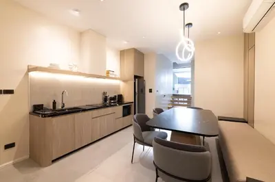 a kitchen and dining room with a table and chairs at P Villas Patong in Patong Beach