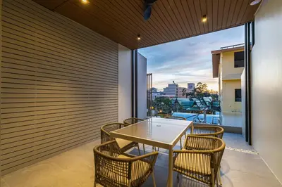 a dining room with a table and chairs at P Villas Patong in Patong Beach