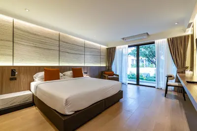 a bedroom with a large bed and a large window at P Villas Patong in Patong Beach