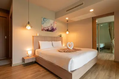 a bedroom with a large white bed with two lights at Breathtaking Sea & Mountain View Private Pool in Karon Beach