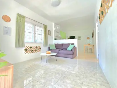 a living room with a purple couch and a table at Village Beach House II in Patong Beach