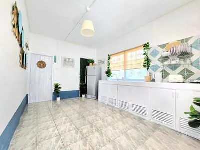 a kitchen with white cabinets and a refrigerator at Village Beach House IV in Patong Beach