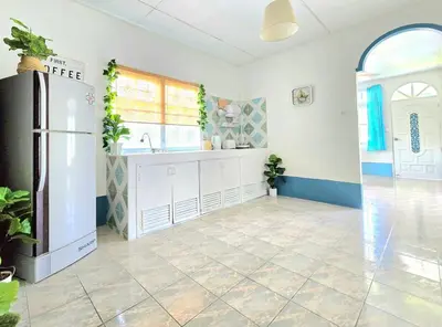 a kitchen with a sink and a refrigerator in a room at Village Beach House IV in Patong Beach