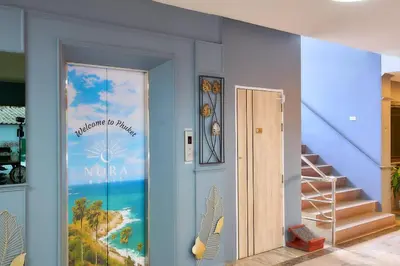 a room with a door with a painting on the wall at Nora Bukit Hotel in Ban Sam Kong