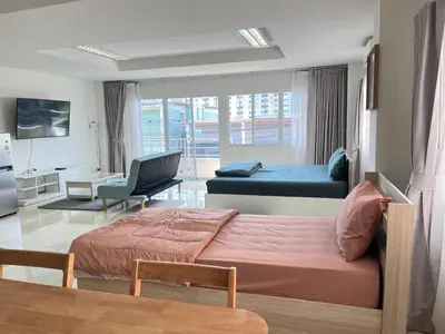 a bedroom with a bed and a desk and a couch at TONY Central Stay in Phuket Town