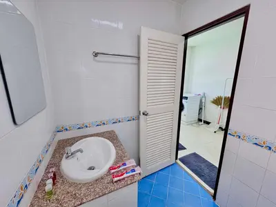 a bathroom with a sink and a mirror at TONY Central Stay in Phuket Town