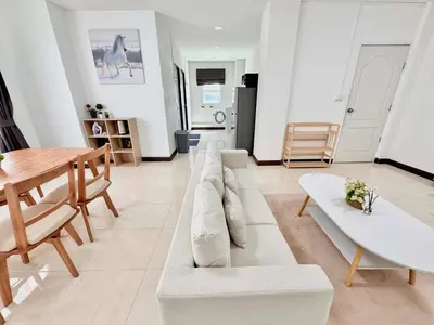 a living room with a couch and a table at TONY Central Stay in Phuket Town