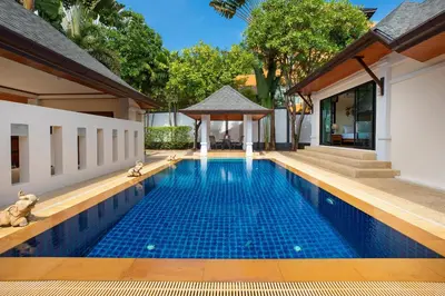 a swimming pool in the middle of a house at Balinese-Style 3Bedrooms Villa Tina in Kata Beach