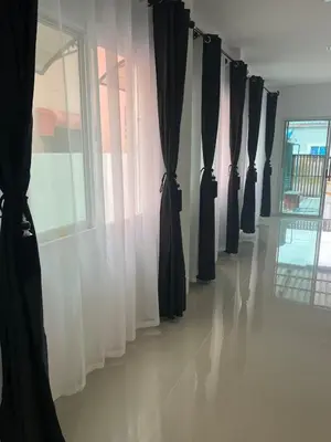 a room with black curtains and a window at Anda Mantham Hill in Ban Bang Rong