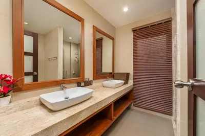 a bathroom with two sinks and a mirror at Oxygen Villas with Private Pool Near Naiharn by TropicLook in Rawai Beach