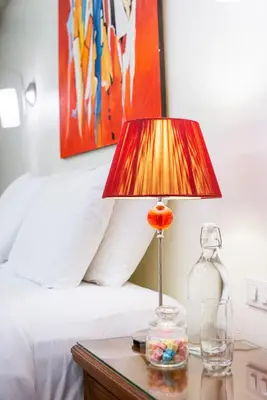 a lamp on a table next to a bed at Lokal Phuket 