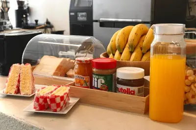 a counter with some food and orange juice and bread at Kuha Phuket Old Town in Phuket Town
