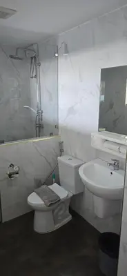 a bathroom with a toilet and a sink and a mirror at Andaman Seaview house rooftop in Patong Beach