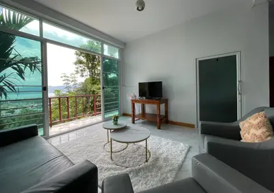 a living room with a couch and a table at Amazing Seaview 2-Bedroom House in Patong in Patong Beach