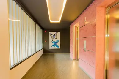 a hallway with pink walls and a large window at Sleek 2 Bed Apt T2-818 in Chalong