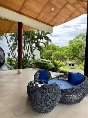 an outdoor patio with two chairs and a table at veloche group 2 in Karon Beach