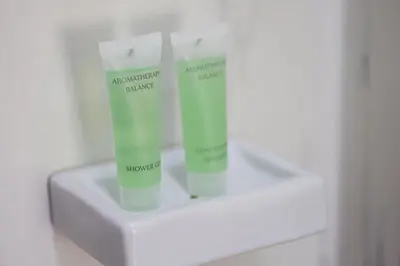 two bottles of moisturizers sitting on top of a counter at StayKa Suites in Karon Beach
