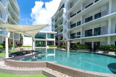 a swimming pool in front of a building at Duplex in NaiHarn Residence near the Beach, UTL B325 in Rawai Beach
