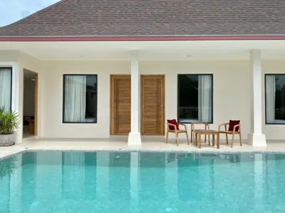 a villa with a swimming pool and a house at Dutch Villas Phuket in Koh Lone