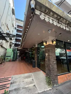 an outside view of a restaurant with a brick building at Beach Comber in Patong Beach