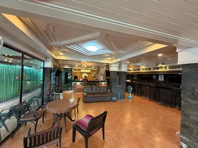 a lobby with a table and chairs and a couch at Beach Comber in Patong Beach