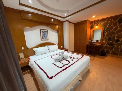 a bedroom with a bed with a towel on it at Beach Comber in Patong Beach