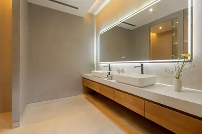 a bathroom with two sinks and a large mirror at Layana Residence in Layan Beach