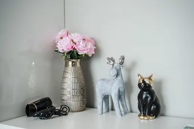 a vase with a deer and a cat on a shelf at C176 Diamond Paradise Getaway Condo Phuket in Bang Tao Beach