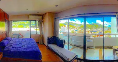 a bedroom with a bed and a large window at Patong Tower in Patong Beach